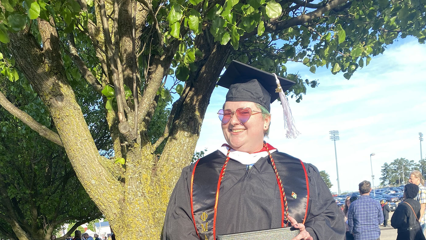 Class of '19 alum Finley Cowlishaw in graduation cap and gown.